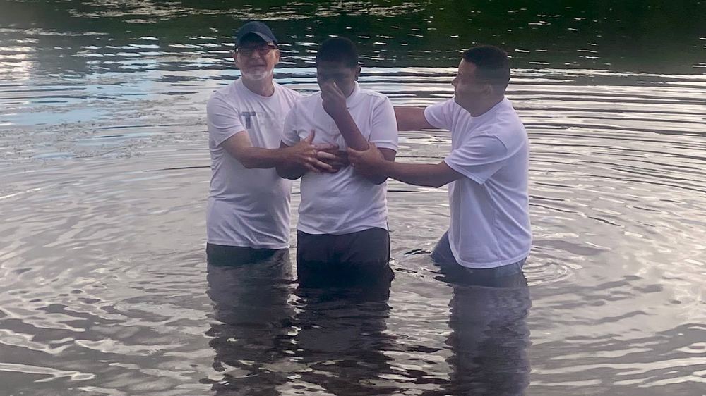 A believer being baptized in the lake at a Carisma Church baptism