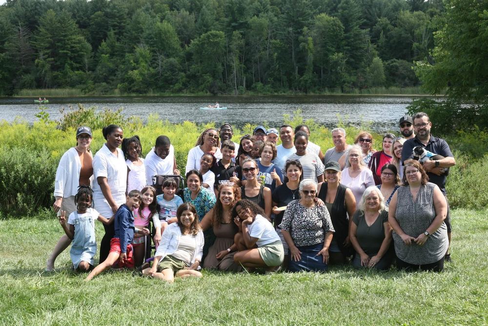 The Carisma Church family together by the lake on a summer day